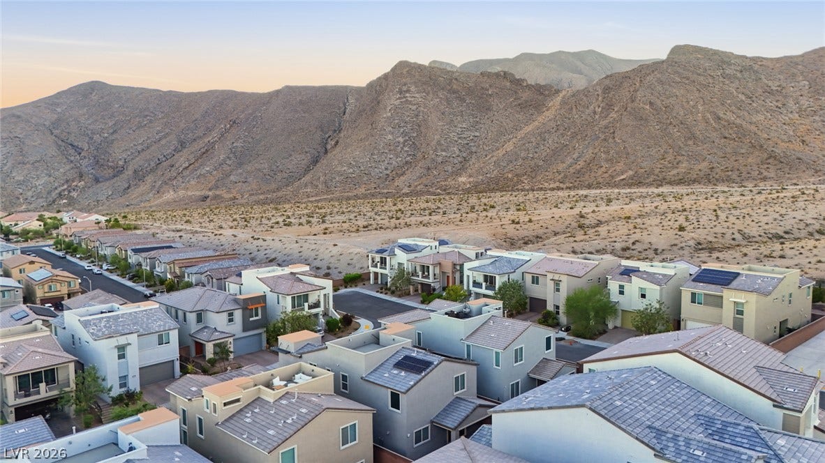 Dramatic mountain peaks frame this modern desert neighborhood.