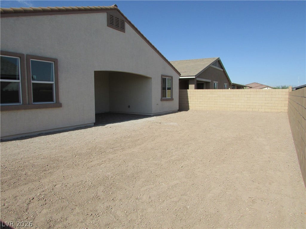 510 CHESTNUT FALCON AVE, Henderson, NV 89011 A spacious backyard area awaits personalization with a covered patio. Photo is Actual Home.