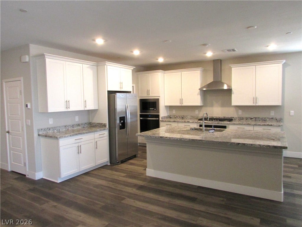 510 CHESTNUT FALCON AVE, Henderson, NV 89011 Culinary creations come to life in this kitchen, boasting abundant counter space and modern appliances. Photo is actual home.