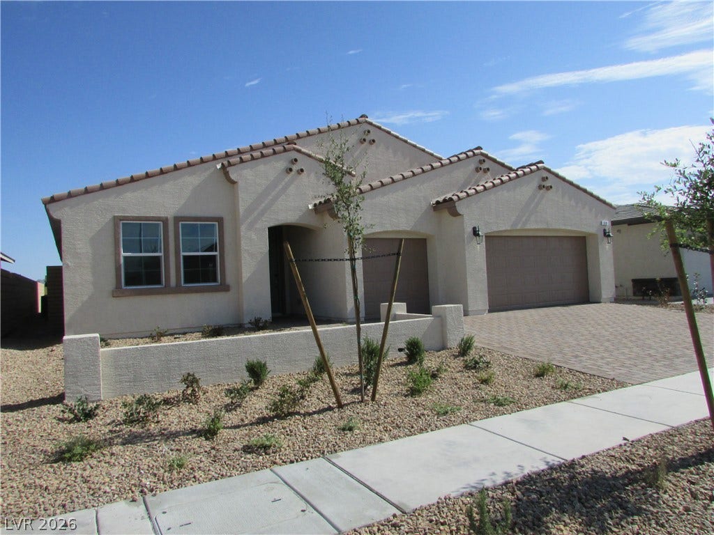 510 CHESTNUT FALCON AVE, Henderson, NV 89011 A well-maintained stucco facade with a tiled roof offers inviting curb appeal. Photo is Actual Home.