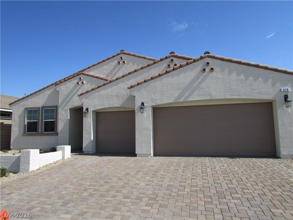 510 CHESTNUT FALCON AVE, Henderson, NV 89011 A charming stucco home with a terracotta tile roof and a spacious paver driveway leads to a two-car garage. Photo is Actual Home.