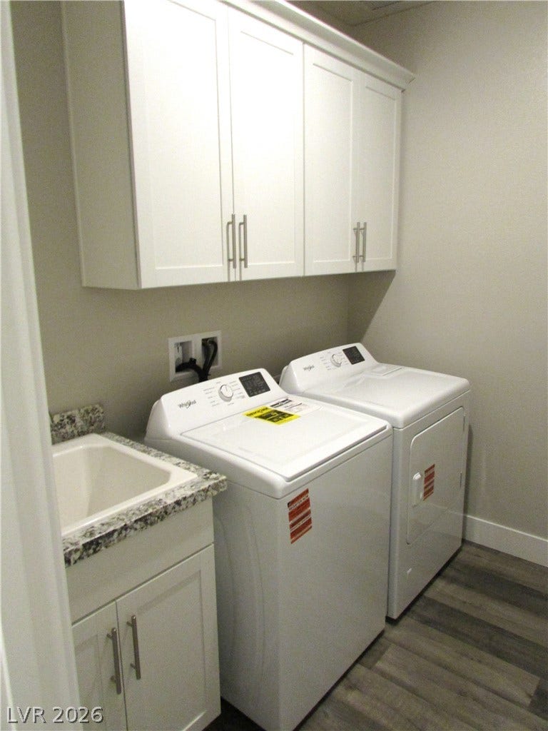 510 CHESTNUT FALCON AVE, Henderson, NV 89011 Functional laundry room featuring a utility sink and white cabinetry for organized storage. Photo is actual home.