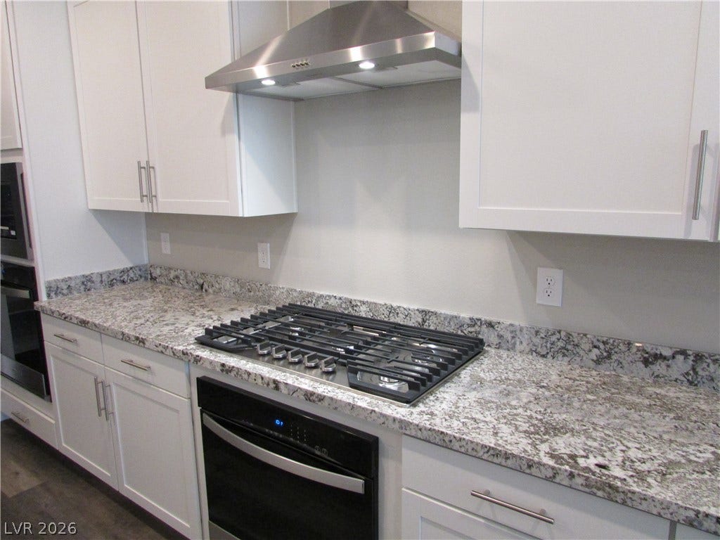 510 CHESTNUT FALCON AVE, Henderson, NV 89011 Gleaming granite countertops and stainless steel appliances define this well-appointed culinary space.