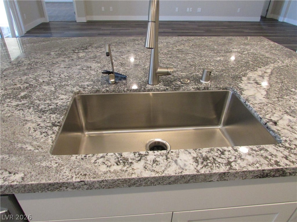 510 CHESTNUT FALCON AVE, Henderson, NV 89011 A deep basin sink is set into an island with flecked stone counters.