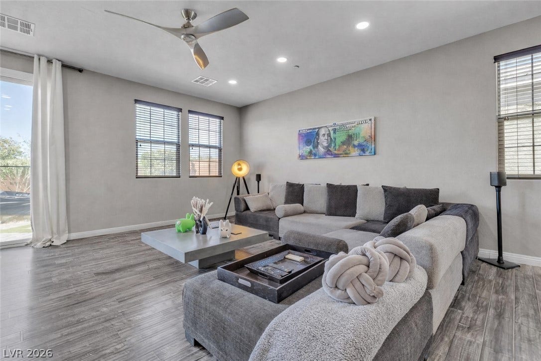 3106 Berceto Court, Henderson, NV 89044 A well-lit living space features sleek wood flooring and a modern ceiling fan for optimal comfort.