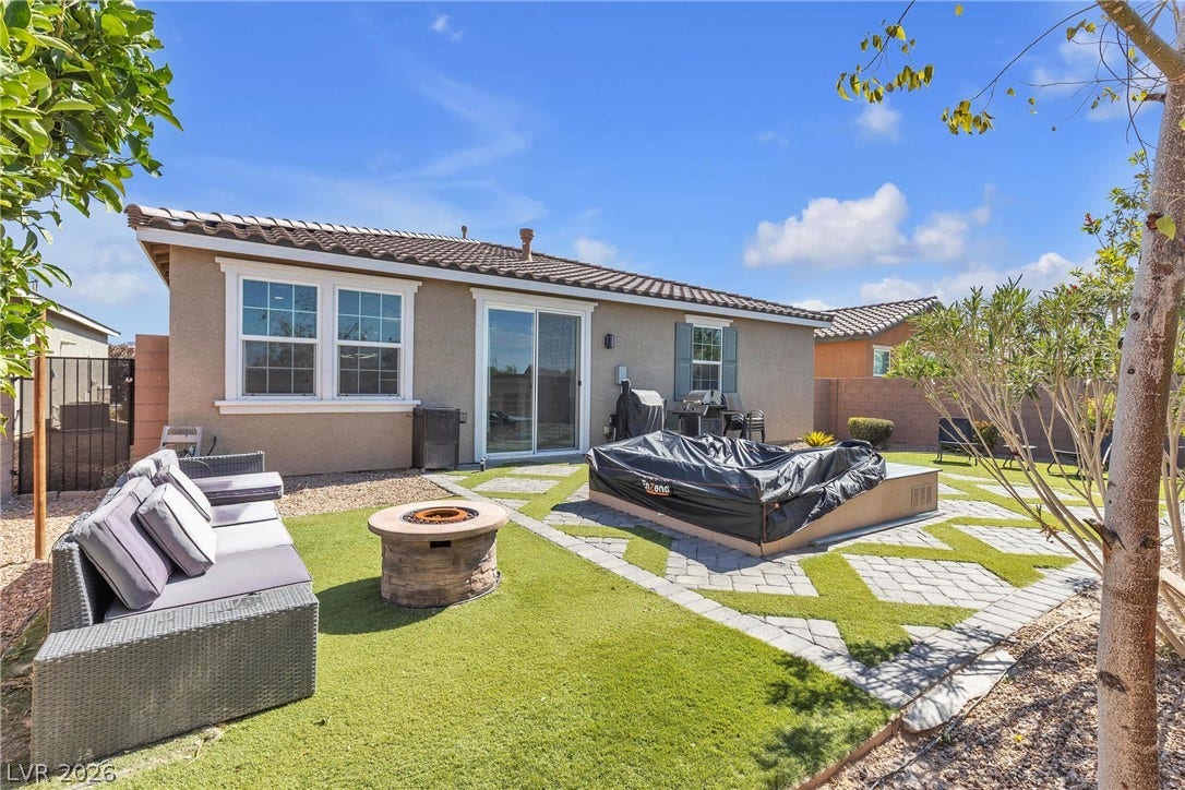 3106 Berceto Court, Henderson, NV 89044 Enjoy outdoor gatherings on the patio, complete with a cozy fire pit and a sliding glass door for easy access.