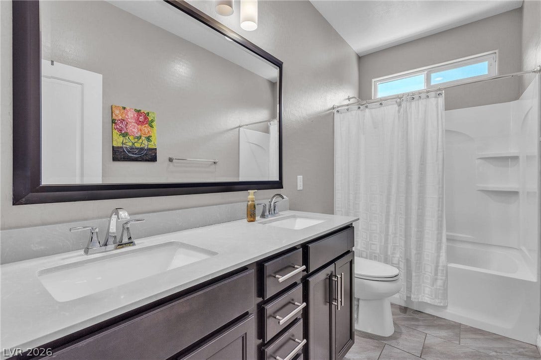 3106 Berceto Court, Henderson, NV 89044 Double vanity sinks and an overhead window illuminate this well-appointed bath.