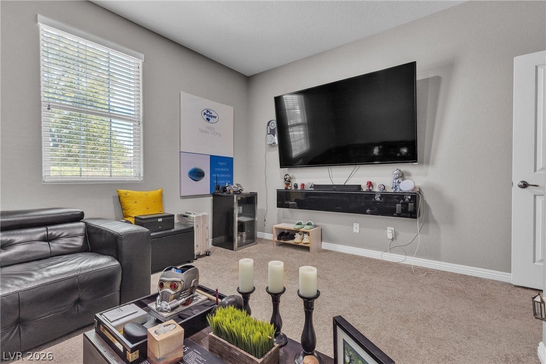 3106 Berceto Court, Henderson, NV 89044 Plush carpeting and a large window offer comfort in this cozy living area.