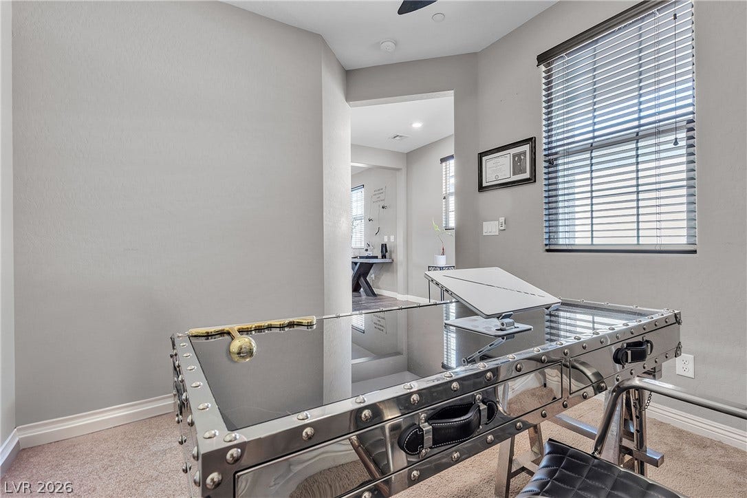 3106 Berceto Court, Henderson, NV 89044 A well-lit study with neutral walls and carpet, offering a dedicated space for productivity.