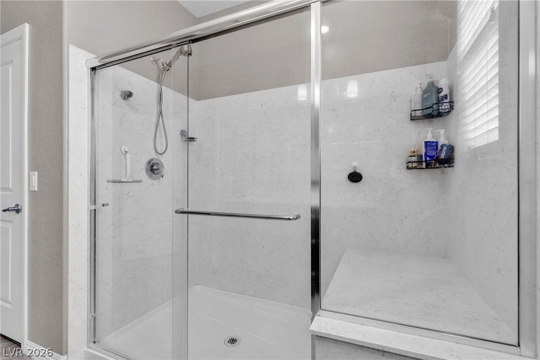 3106 Berceto Court, Henderson, NV 89044 A generously proportioned walk-in shower features a convenient built-in bench.
