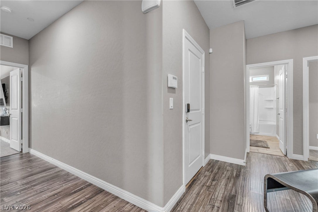 3106 Berceto Court, Henderson, NV 89044 Hardwood-style flooring extends through this central hallway, connecting various rooms with ease.