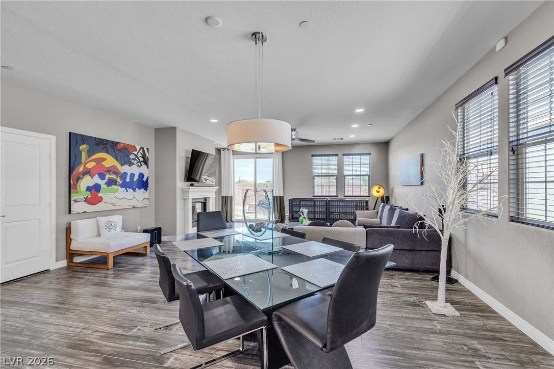 3106 Berceto Court, Henderson, NV 89044 An open concept living and dining area boasts rich hardwood flooring and abundant natural light.