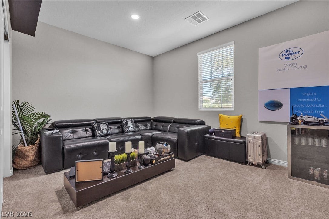 3106 Berceto Court, Henderson, NV 89044 A versatile living area features carpeted floors and a spacious L-shaped sofa, offering comfort and style.