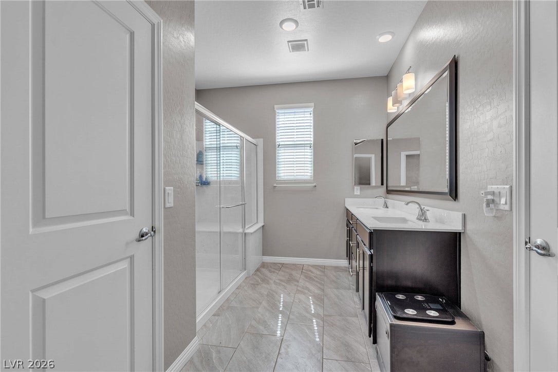 3106 Berceto Court, Henderson, NV 89044 Dual vanities and a spacious shower create a serene bathing experience.