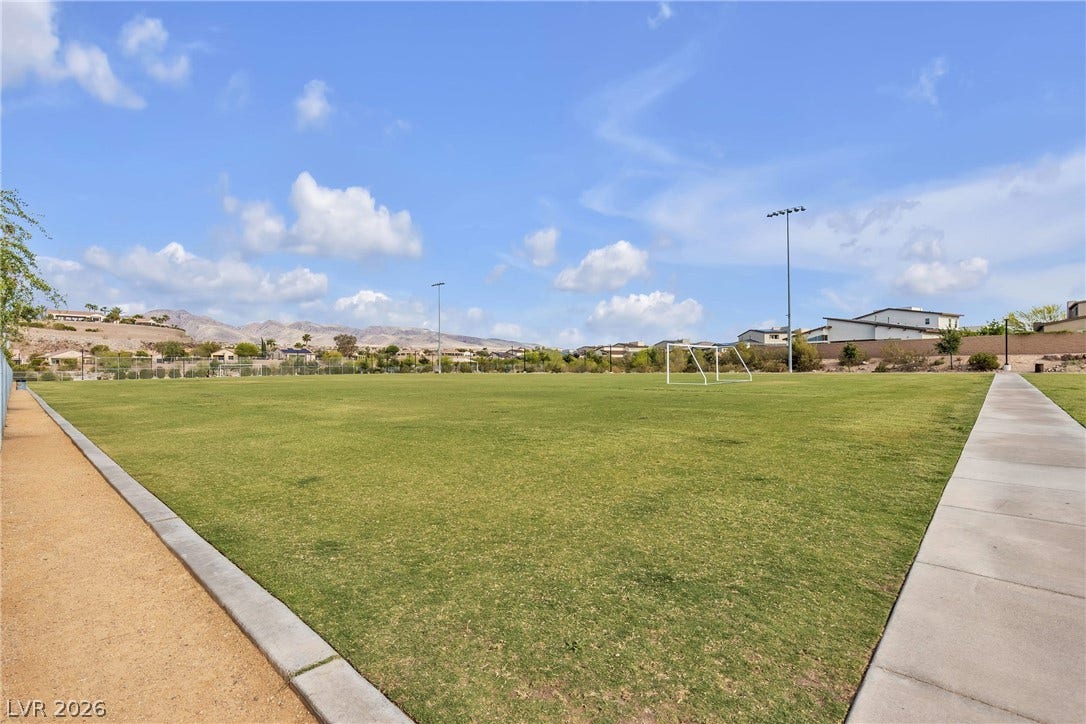 3106 Berceto Court, Henderson, NV 89044 A vast, green recreational field with soccer goals awaits active leisure under the clear blue sky.