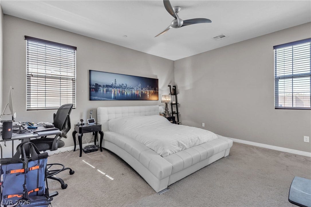 3106 Berceto Court, Henderson, NV 89044 Discover a naturally illuminated bedroom featuring plush carpeting and a contemporary ceiling fan.
