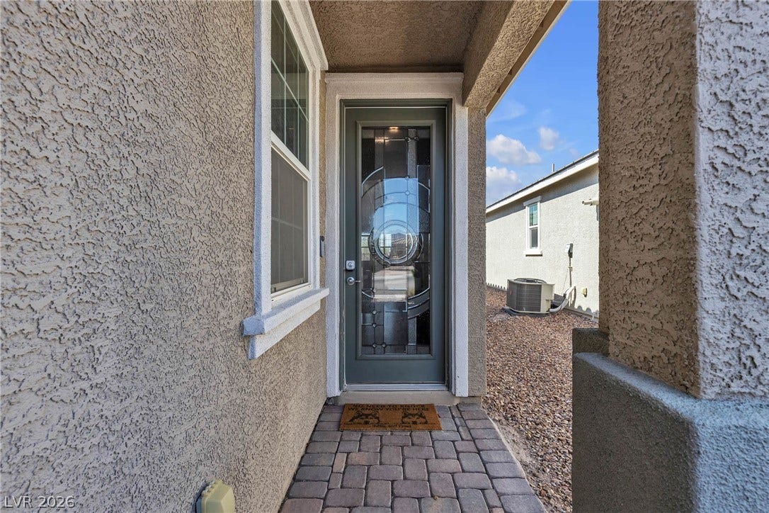 3106 Berceto Court, Henderson, NV 89044 A welcoming entry invites with a decorative glass door and durable paver pathway.