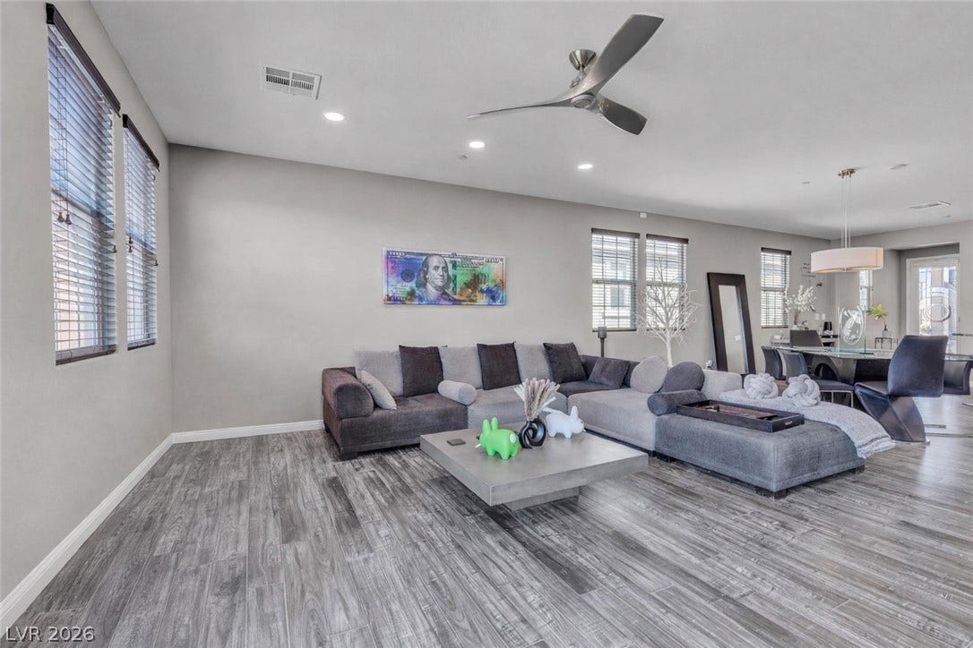 3106 Berceto Court, Henderson, NV 89044 An inviting gathering space boasts sleek, wood-look flooring and ample natural light.