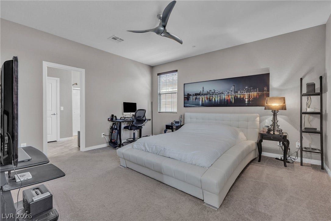3106 Berceto Court, Henderson, NV 89044 An inviting bedroom features a contemporary bed frame, soft carpeting, and a sleek ceiling fan.
