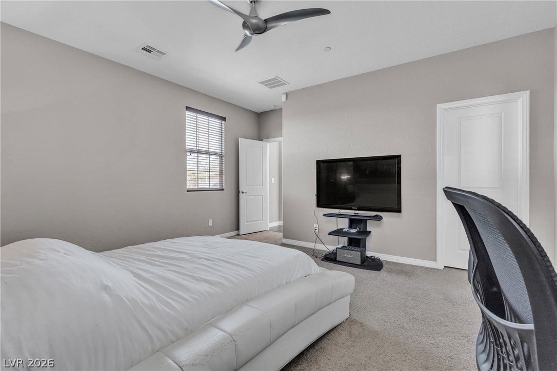 3106 Berceto Court, Henderson, NV 89044 Well-appointed bedroom featuring a contemporary ceiling fan and ample natural light from a window with blinds.