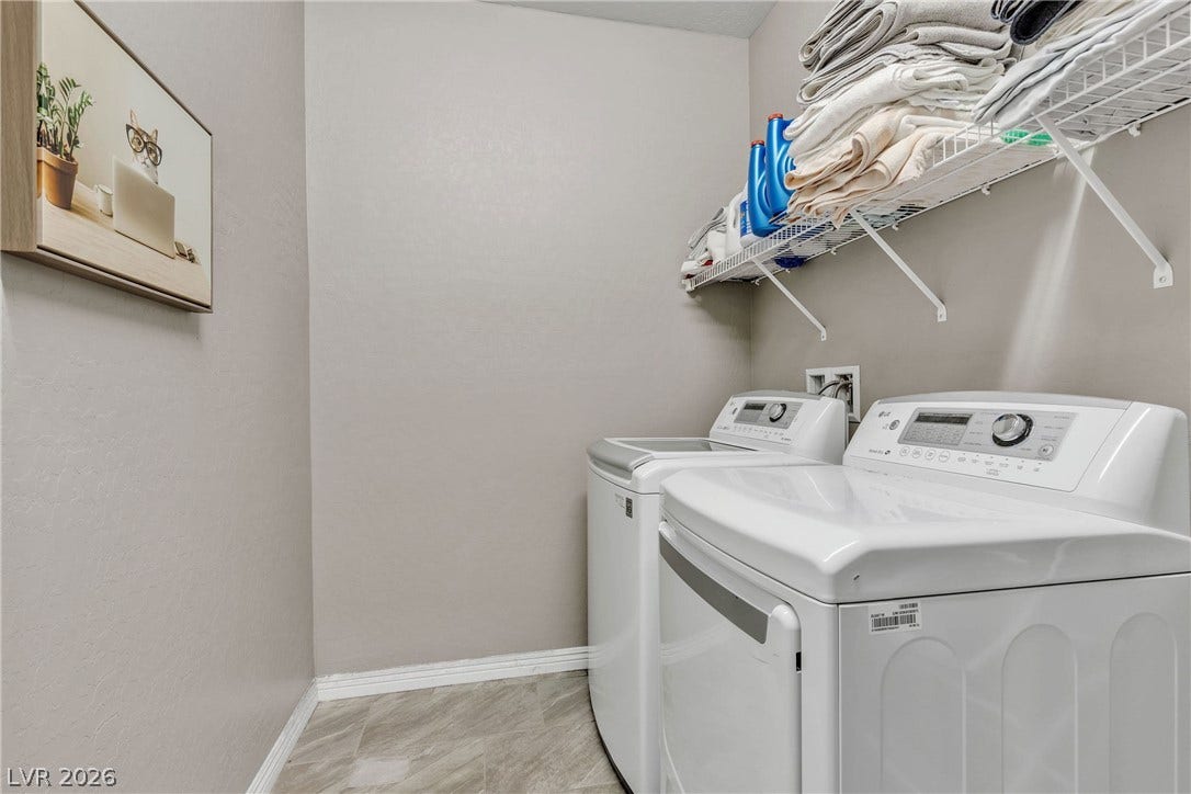3106 Berceto Court, Henderson, NV 89044 Functional laundry space featuring modern appliances and convenient overhead shelving.