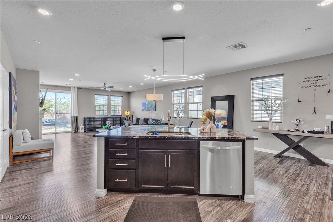 3106 Berceto Court, Henderson, NV 89044 A well-lit open-concept living space with sleek flooring and modern kitchen island.