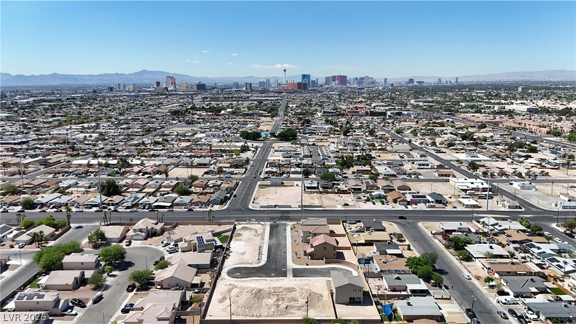 2405 Copperbelt Street, Las Vegas, NV 89030 An aerial perspective showcases a vibrant urban landscape with distant city views.