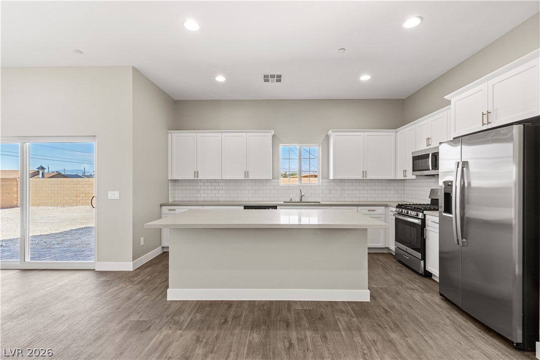 2405 Copperbelt Street, Las Vegas, NV 89030 A well-lit kitchen with sleek countertops and modern appliances, perfect for culinary endeavors.