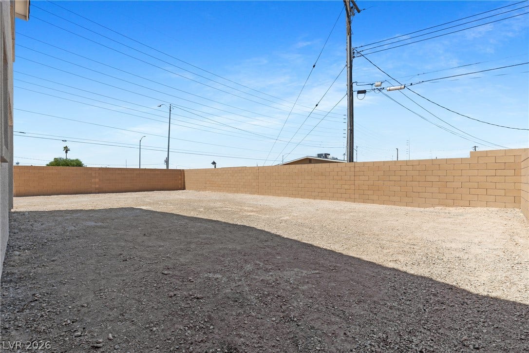 2405 Copperbelt Street, Las Vegas, NV 89030 A spacious, bare yard awaits your landscaping vision, enclosed by sturdy block walls.