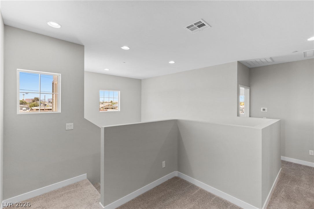 2405 Copperbelt Street, Las Vegas, NV 89030 A well-lit upper landing, ideal for a flexible bonus area, provides clear sightlines to the neighborhood.