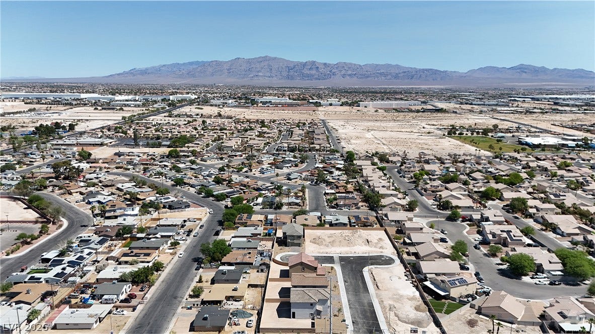 2405 Copperbelt Street, Las Vegas, NV 89030 Overlooking a desert community with mountain vistas, this aerial captures expansive suburban living.