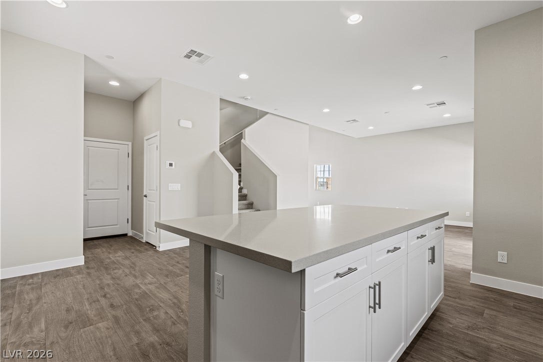 2405 Copperbelt Street, Las Vegas, NV 89030 A central kitchen island with ample counter space anchors this open-concept living area.