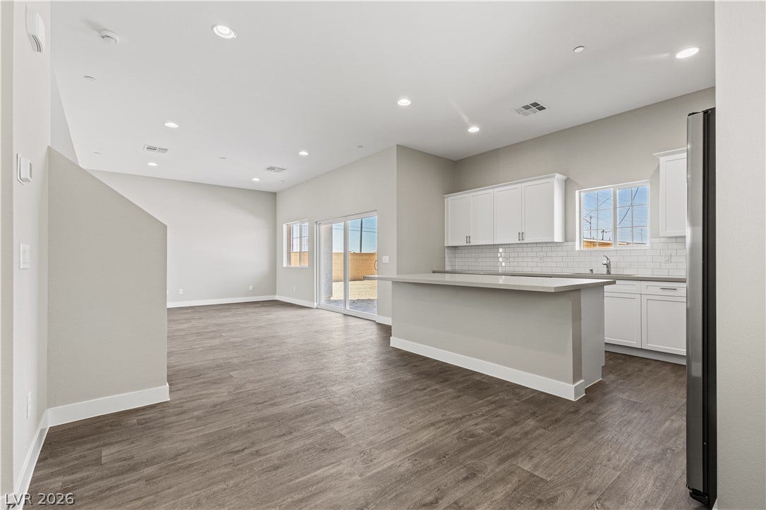 2405 Copperbelt Street, Las Vegas, NV 89030 An open-concept living space with a modern kitchen island and direct outdoor access.