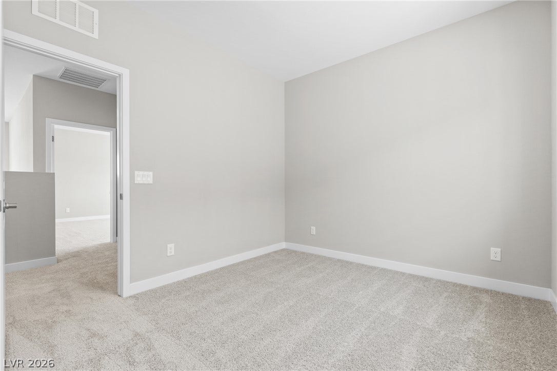 2405 Copperbelt Street, Las Vegas, NV 89030 An inviting room, ready for personal touches, features soft carpeting and clean, neutral walls.