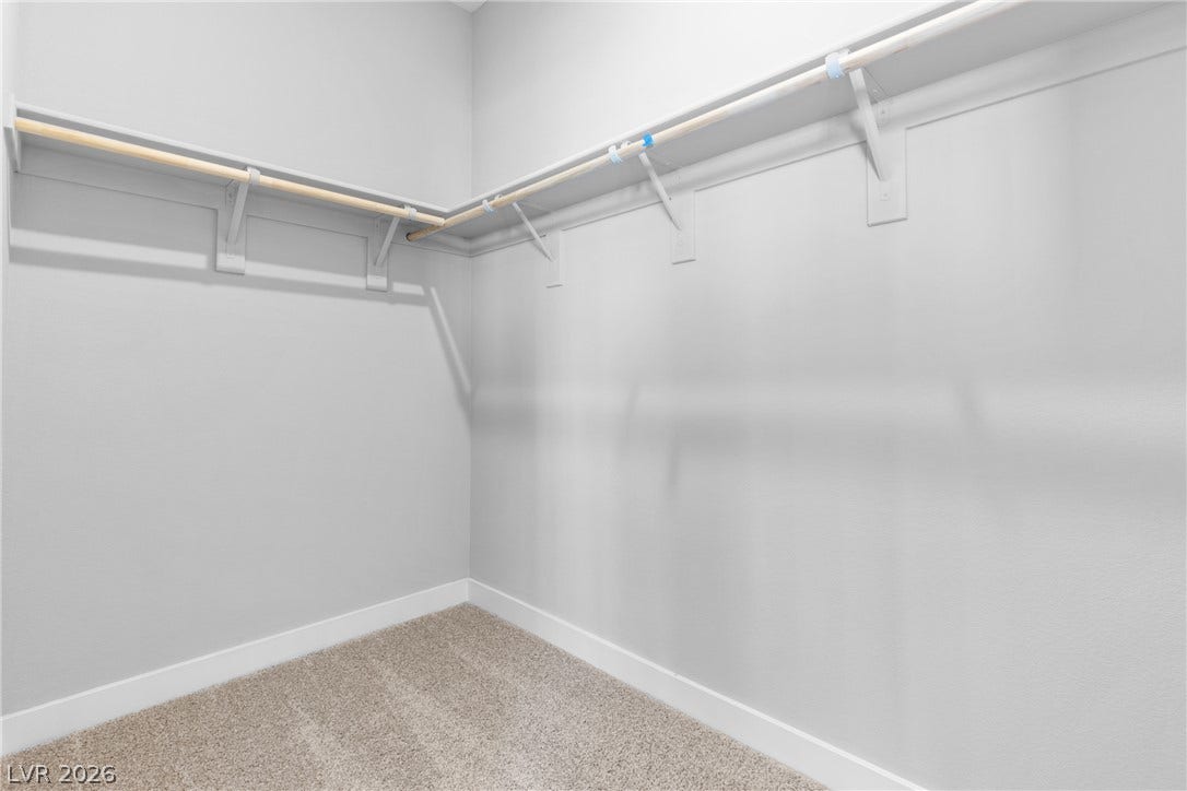 2405 Copperbelt Street, Las Vegas, NV 89030 A well-organized closet space offers practical storage solutions with built-in shelving and hanging rods.