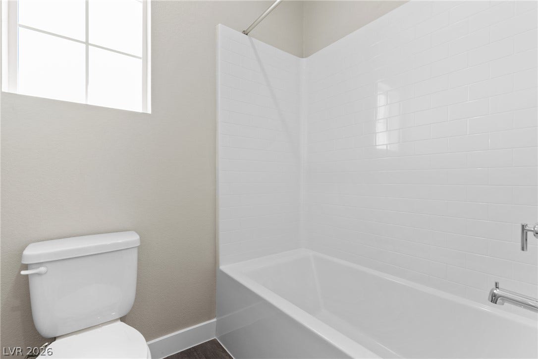 2405 Copperbelt Street, Las Vegas, NV 89030 A well-lit bathroom provides a comfortable bath and a window for natural light.