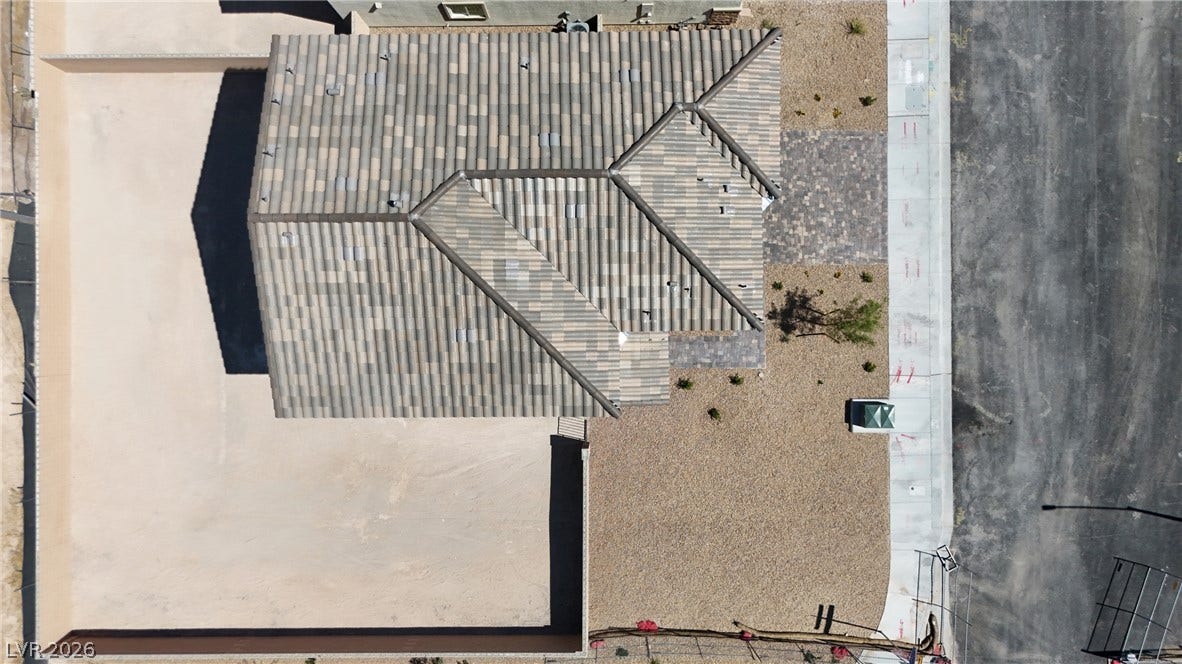 2405 Copperbelt Street, Las Vegas, NV 89030 An aerial perspective showcases the new tile roof and meticulously graveled landscaping surrounding the structure.