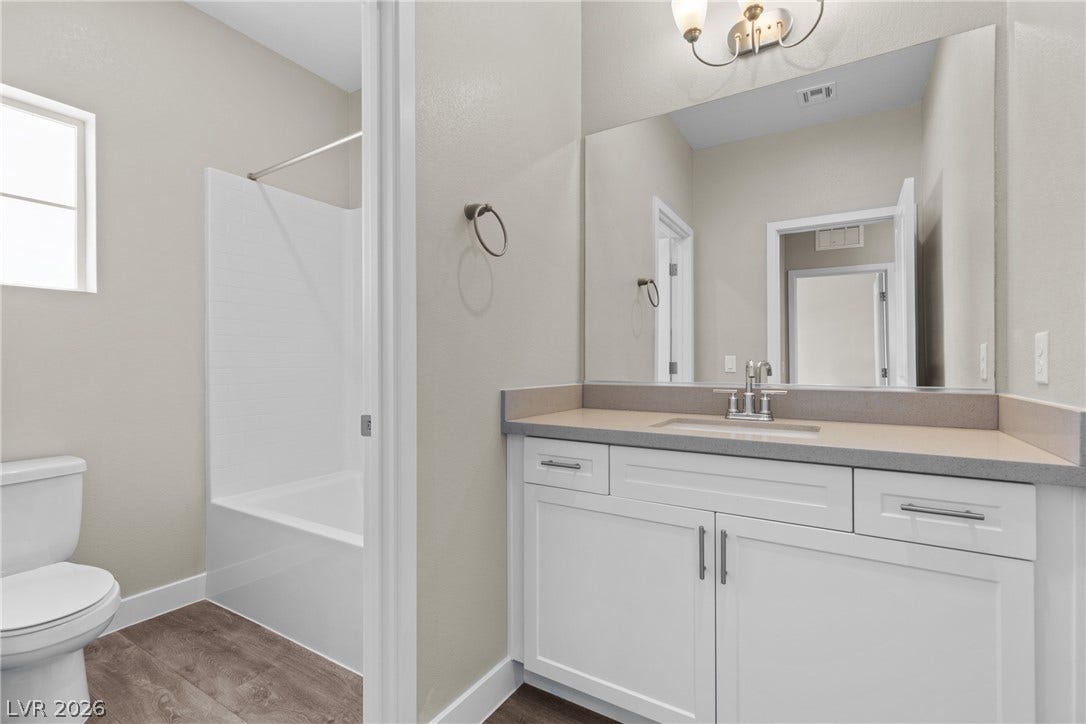 2405 Copperbelt Street, Las Vegas, NV 89030 A well-appointed bathroom with a vanity and modern fixtures.