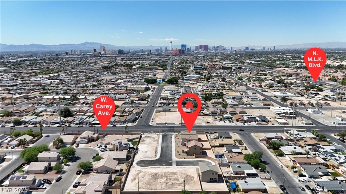 2405 Copperbelt Street, Las Vegas, NV 89030 An aerial perspective showcases a vibrant urban landscape with distant mountains under a clear sky.