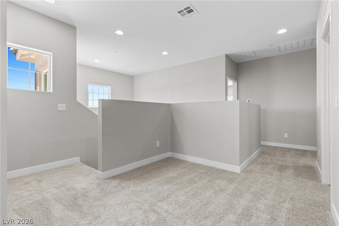 2405 Copperbelt Street, Las Vegas, NV 89030 A versatile open loft area provides additional living space with plush carpeting and natural light.