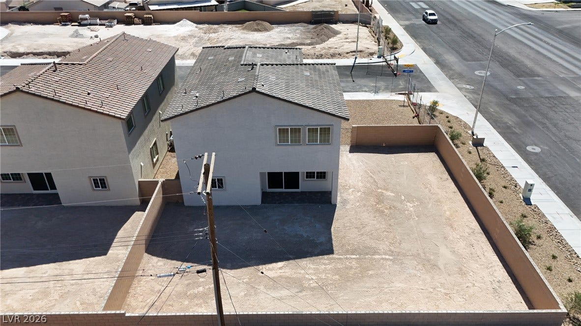2405 Copperbelt Street, Las Vegas, NV 89030 An aerial view showcases a newly constructed residence with a spacious, ready-to-customize backyard area.