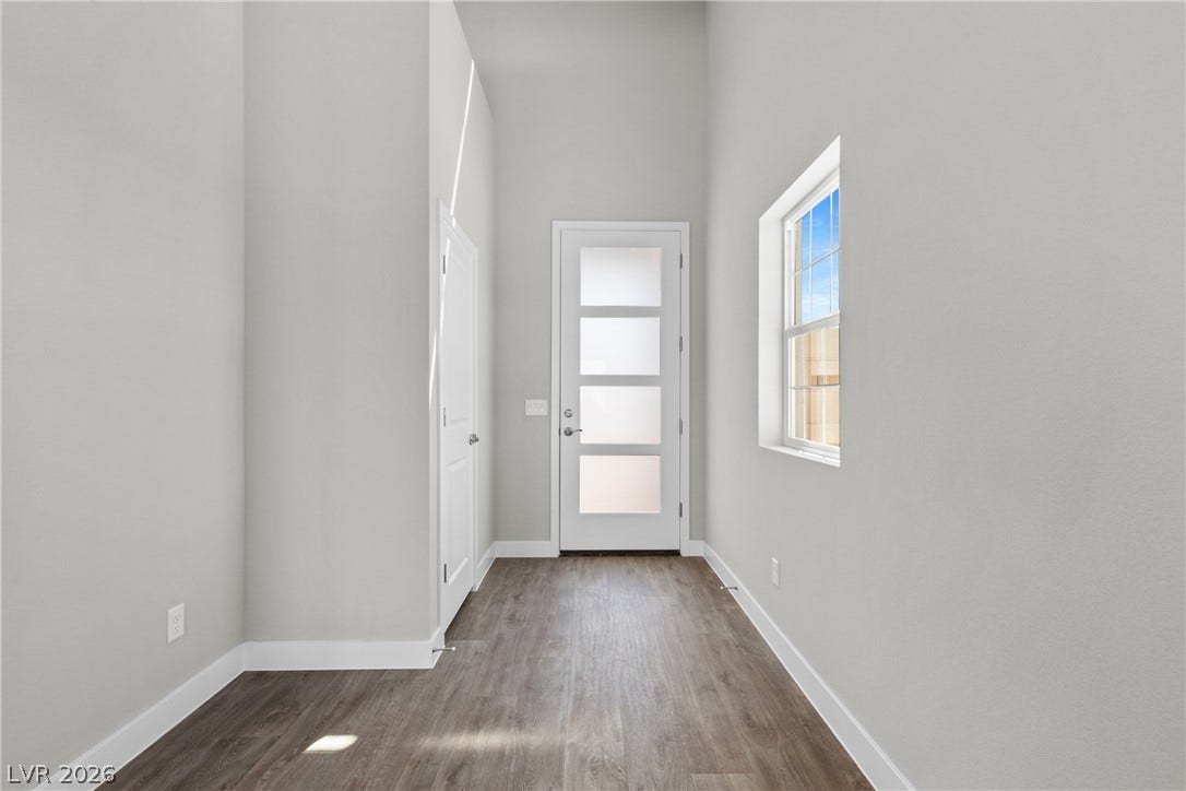 2405 Copperbelt Street, Las Vegas, NV 89030 A welcoming entryway with abundant natural light and modern flooring, hinting at the home's contemporary style.