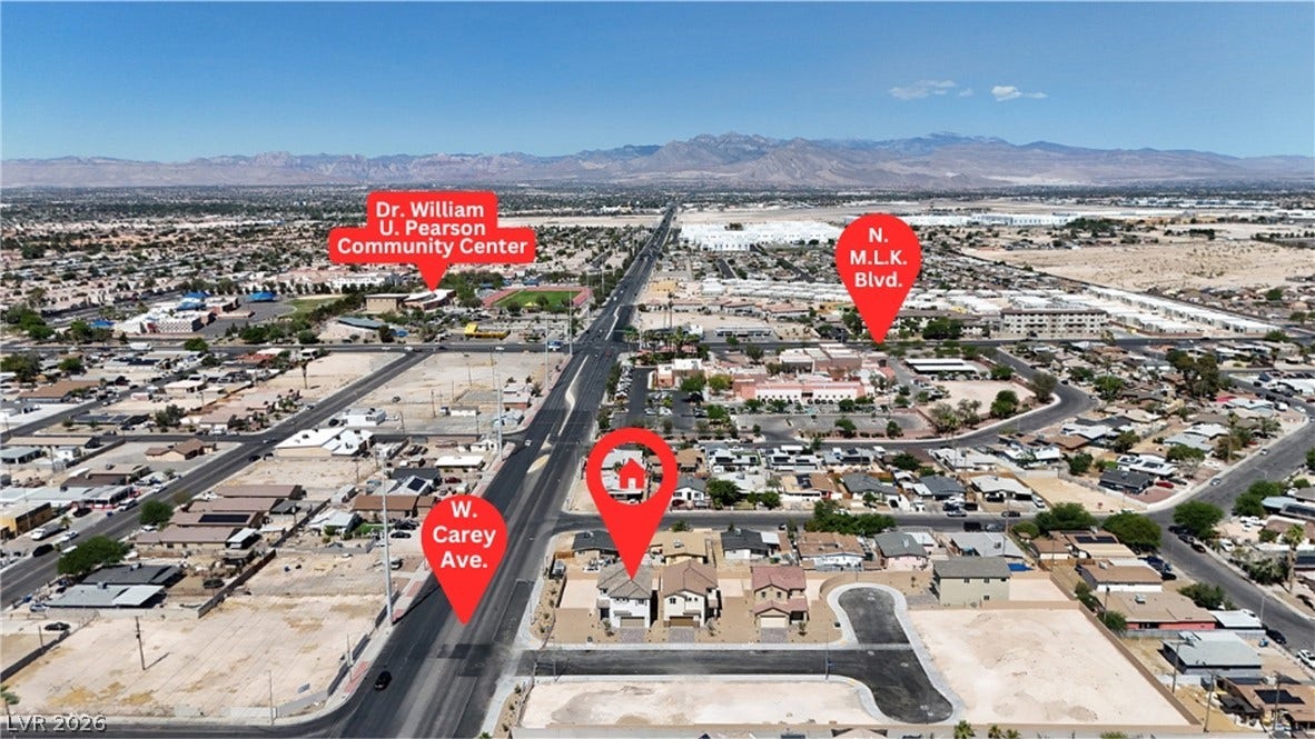 2405 Copperbelt Street, Las Vegas, NV 89030 An aerial perspective reveals a vibrant neighborhood with mountains framing the horizon.