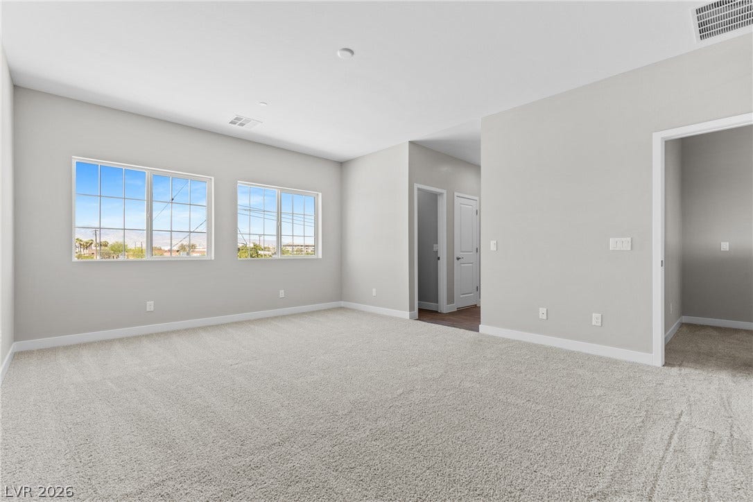 2405 Copperbelt Street, Las Vegas, NV 89030 A spacious and inviting living area awaits, offering a neutral canvas for your personal touch.