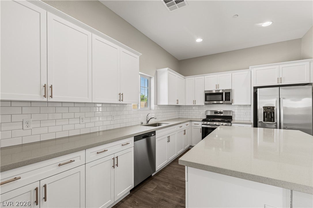 2405 Copperbelt Street, Las Vegas, NV 89030 A streamlined kitchen presents ample counter space and well-appointed, contemporary appliances.