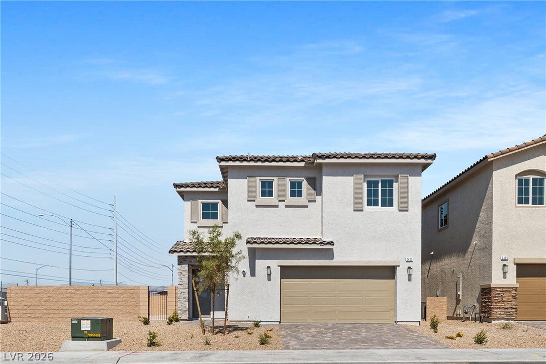 2405 Copperbelt Street, Las Vegas, NV 89030 A new construction home with an attached garage and desert landscaping awaits.