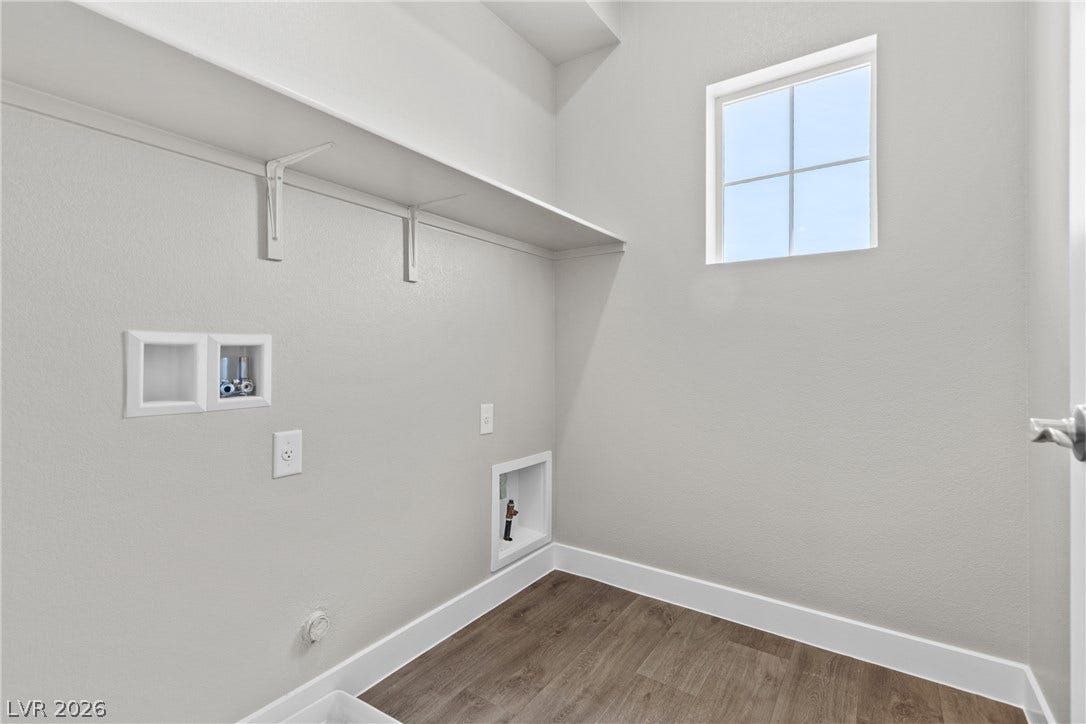 2405 Copperbelt Street, Las Vegas, NV 89030 A dedicated laundry space offers practical utility with an elevated window and shelving.