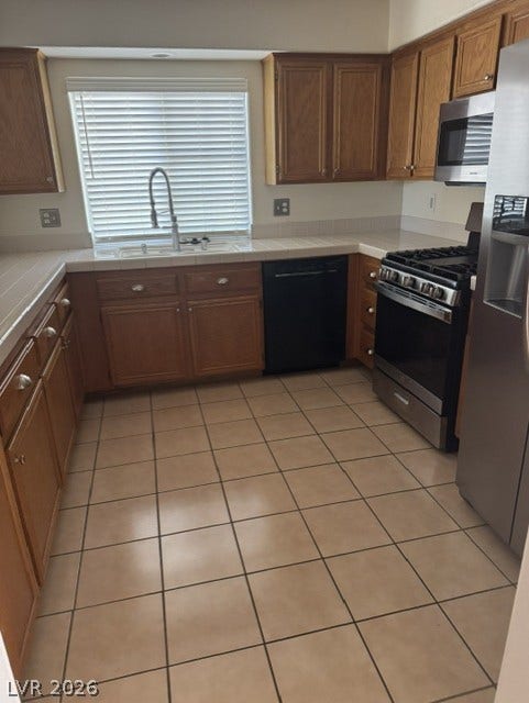 1851 Hillpointe Road, #1412, Henderson, NV 89074 Functional kitchen with ample cabinetry and easy-to-maintain tile flooring.