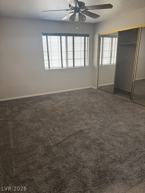 1851 Hillpointe Road, #1412, Henderson, NV 89074 Well-lit room features soft carpeting and a mirrored closet, offering ample storage and comfort.