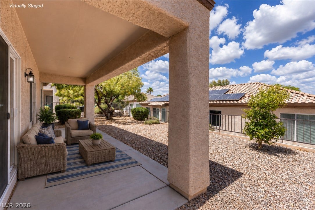 2157 Sawtooth Mountain Drive, Henderson, NV 89044 An inviting covered patio offers a tranquil outdoor retreat amidst a desert-scaped yard.